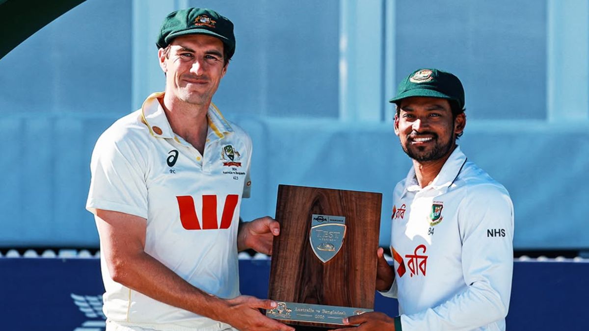 Pat Cummins and Najmul Hossain Shanto pose with a trophy