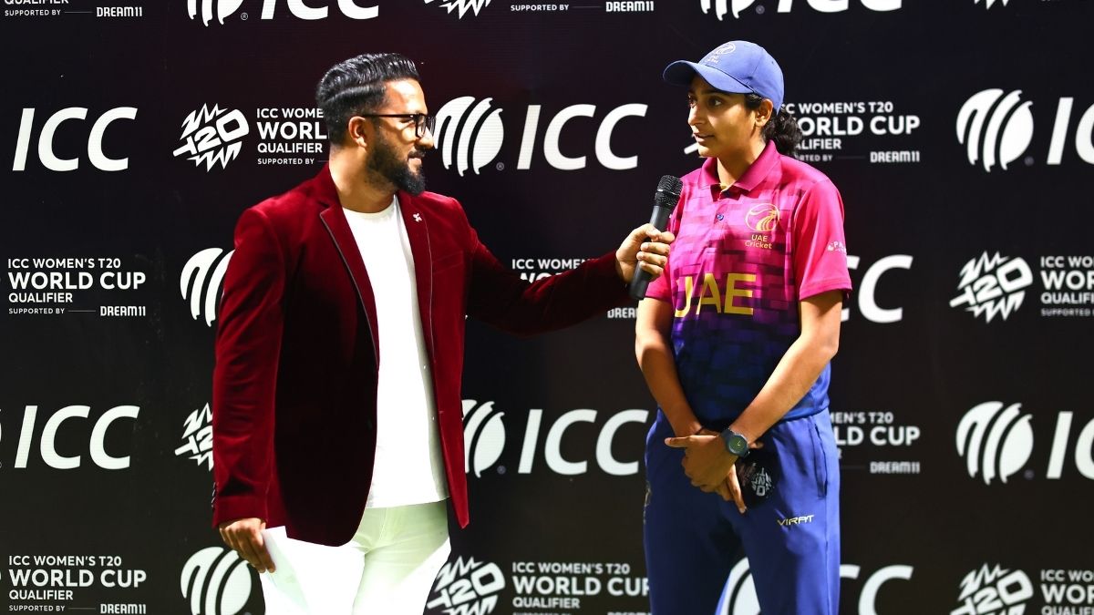 Esha Oza speaks during a post-match presentation
