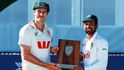 Pat Cummins and Najmul Hossain Shanto pose with a trophy
