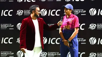 Esha Oza speaks during a post-match presentation
