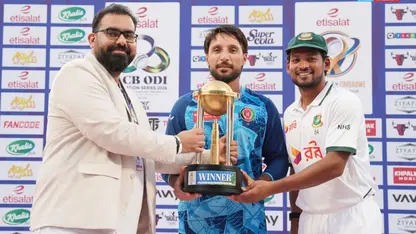 Rahmat Shah and Najmul Hossain Shanto share the trophy after a draw in Abu Dhabi